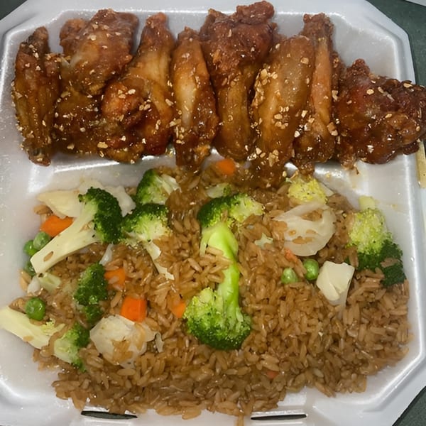 Wings Bomb's honey garlic wings with chopped peanuts and a side of vegetable fried rice.